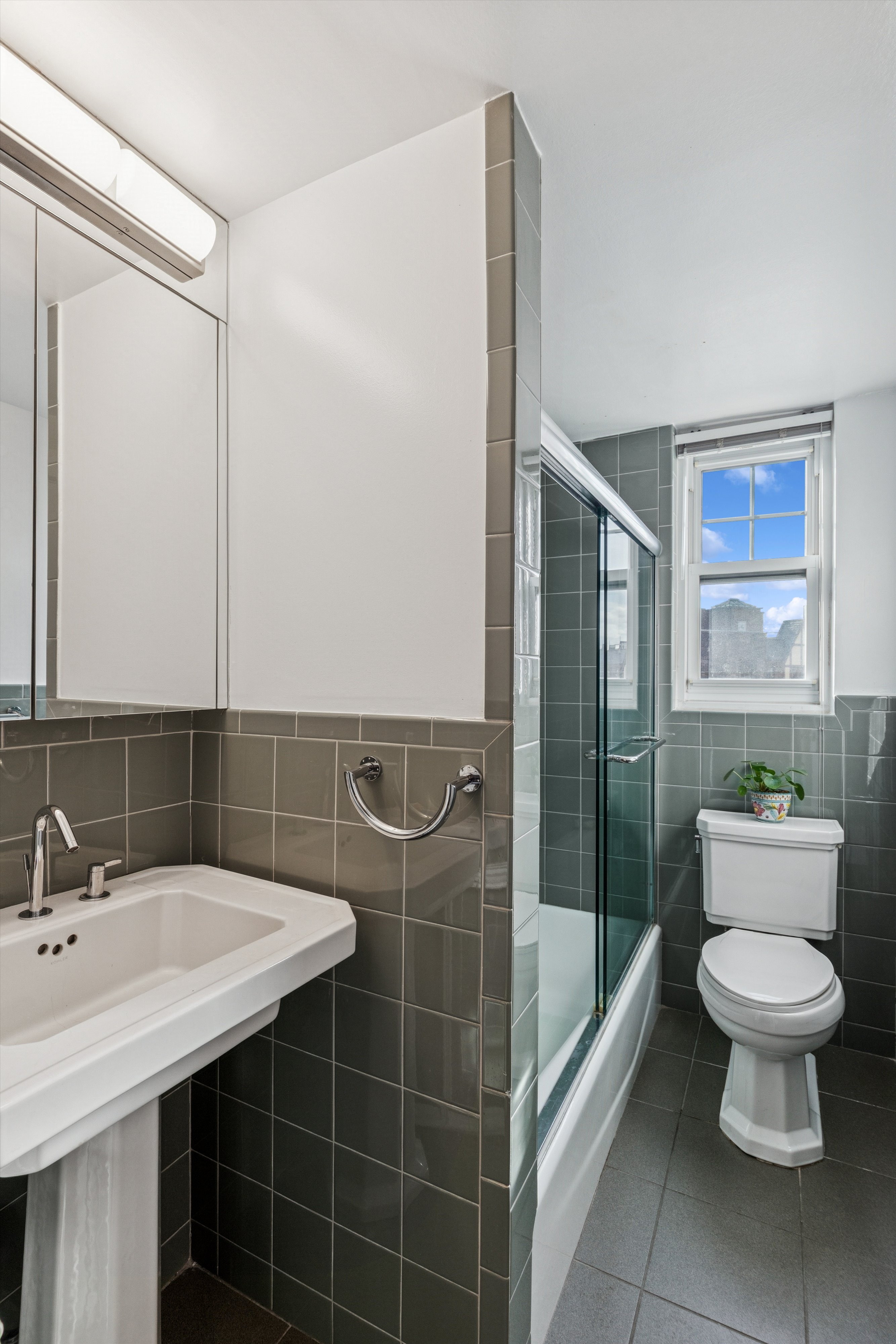 200 Cabrini Boulevard, Unit 86 Manhattan, NY 10033 - Photo 10 of 26 a bathroom with a sink toilet and shower