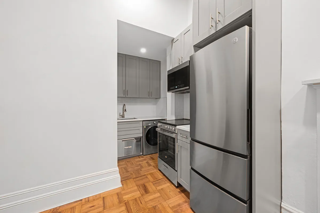 62 West 87th Street, Unit 1F Manhattan, NY 10024 - Photo 4 of 6 a kitchen with a refrigerator and a stove