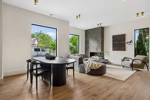 a large kitchen with stainless steel appliances kitchen island granite countertop a sink a stove and a refrigerator