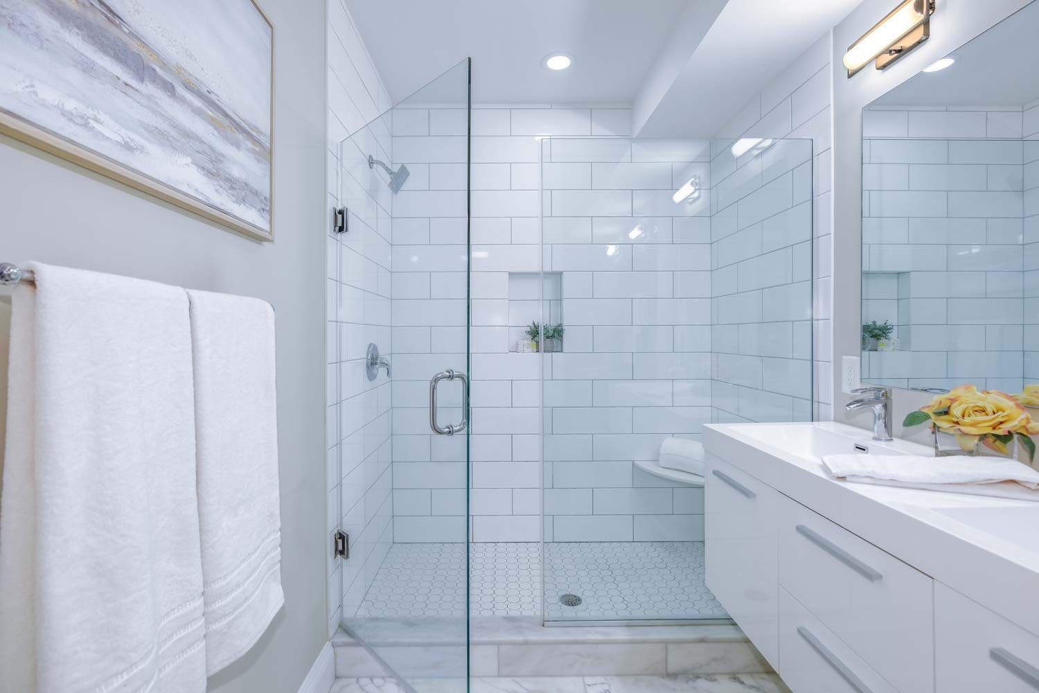 a bathroom with a sink shower and a mirror
