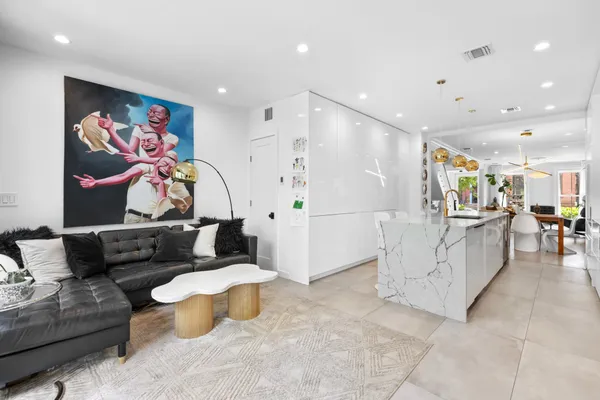 a living room with furniture and wall paintings