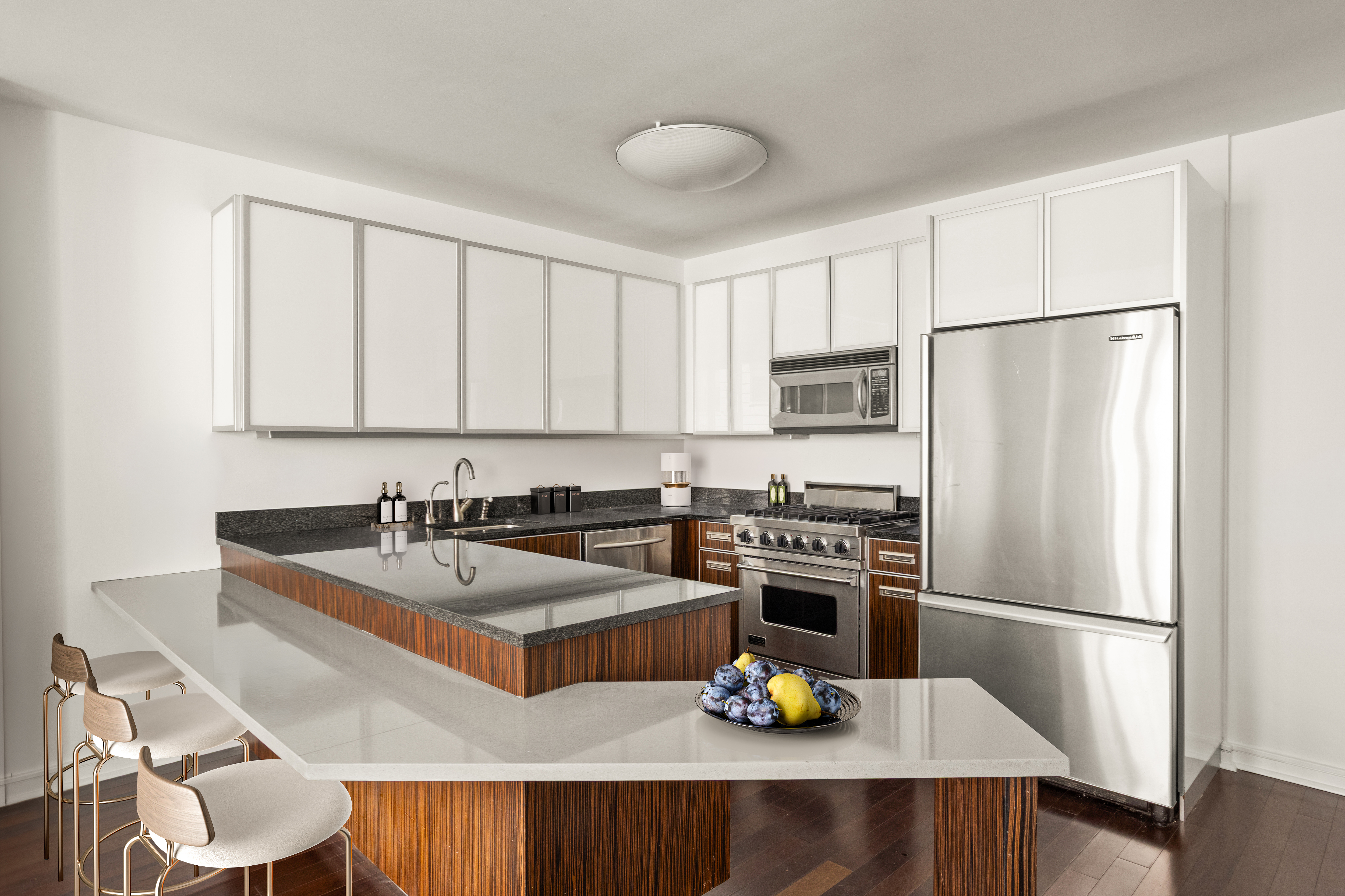 130 West 19th Street, Unit 7C Manhattan, NY 10011 - Photo 5 of 13 a kitchen with a refrigerator a stove a sink and a microwave