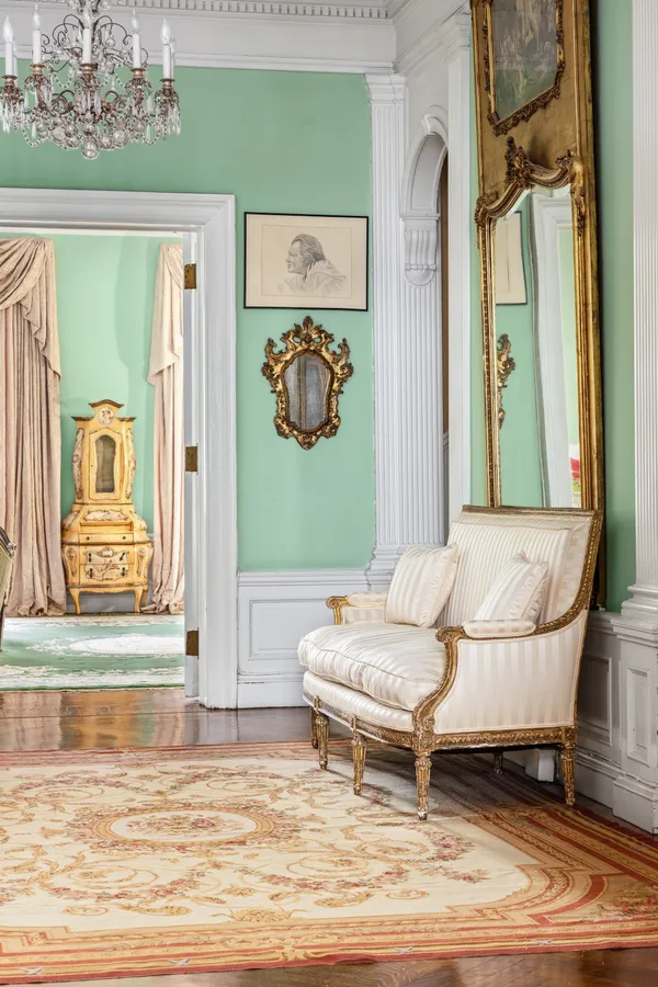 a living room with a rug and a painting on the wall