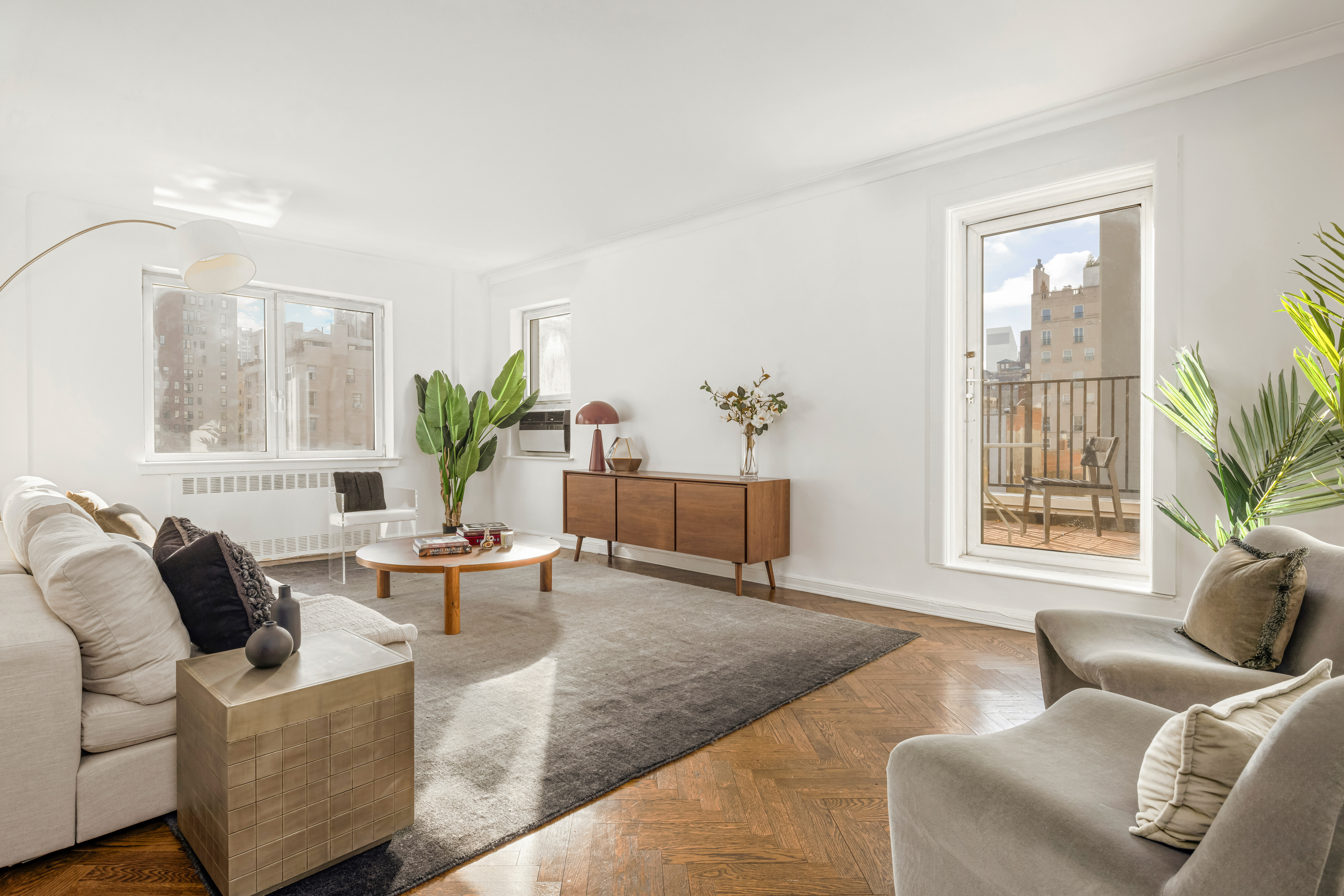 a living room with furniture and potted plant
