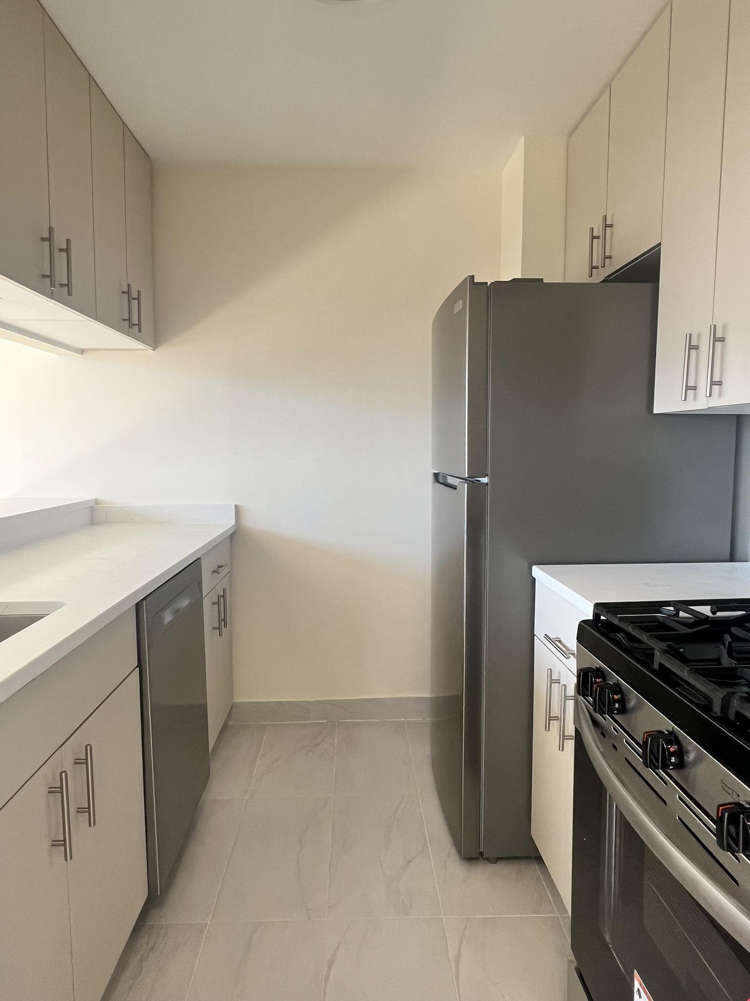 250 West 90th Street, Unit PH2F Manhattan, NY 10024 - Photo 20 of 21 a kitchen with white cabinets and white appliances