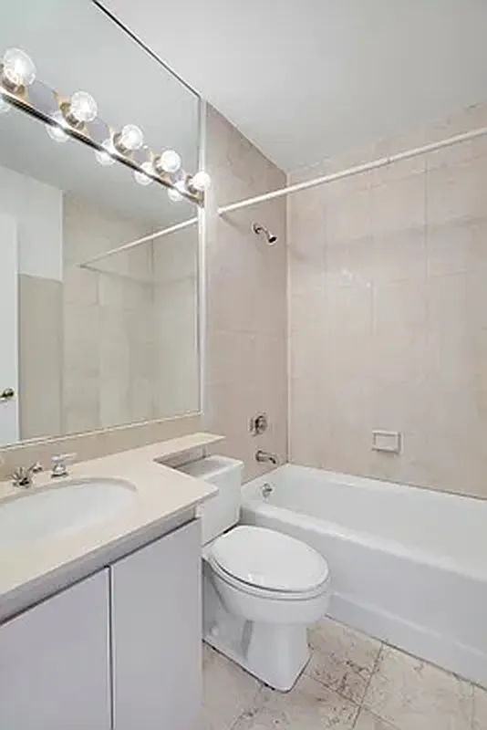 330 East 75th Street, Unit 4D Manhattan, NY 10021 - Photo 5 of 9 a bathroom with a sink a toilet and shower