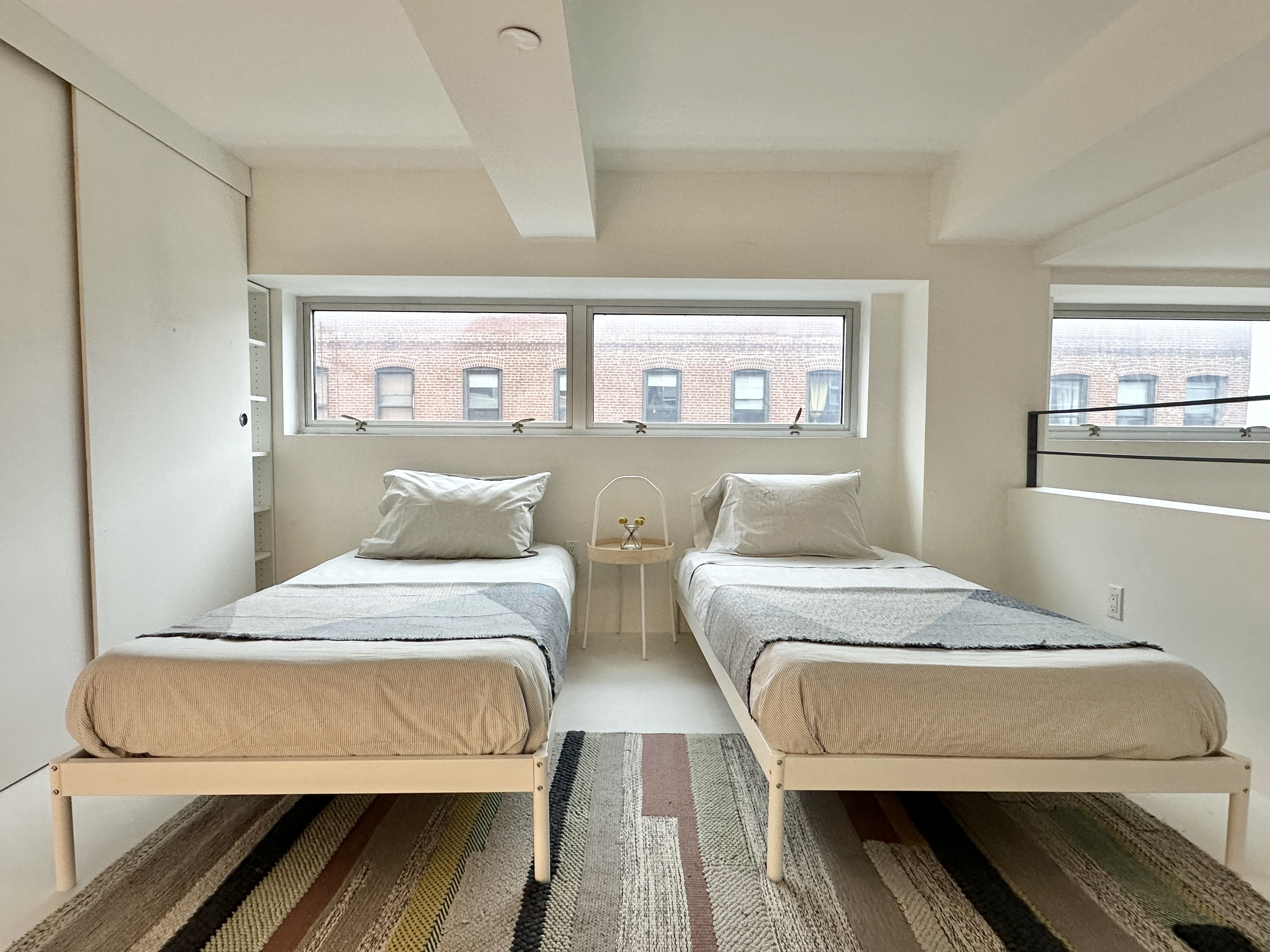 100 North 3rd Street, Unit 3E Brooklyn, NY 11249 - Photo 9 of 15 a bedroom with two beds and a desk