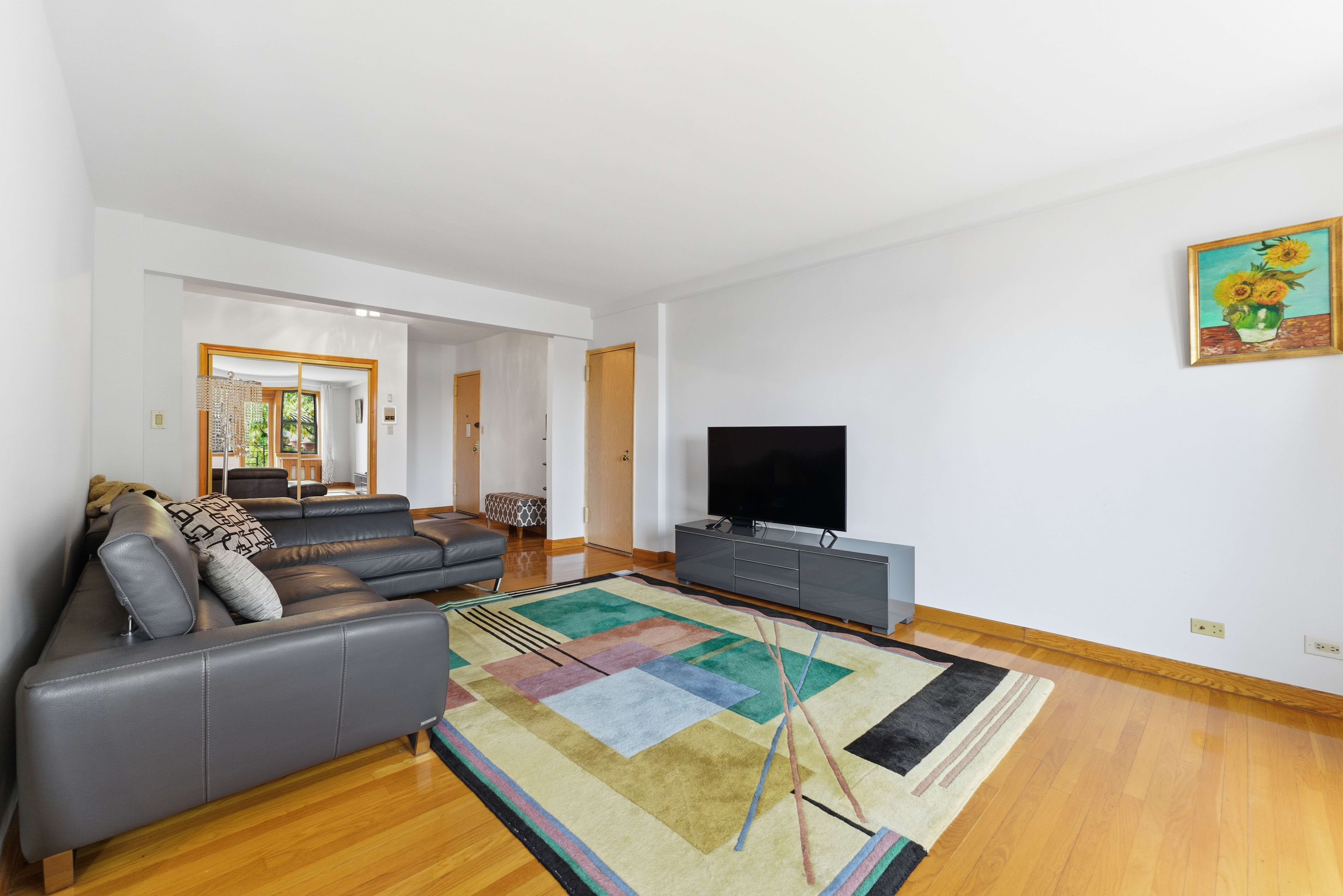 3616 Henry Hudson Parkway, Unit 7GN Bronx, NY 10463 - Photo 3 of 17 a living room with furniture and a flat screen tv