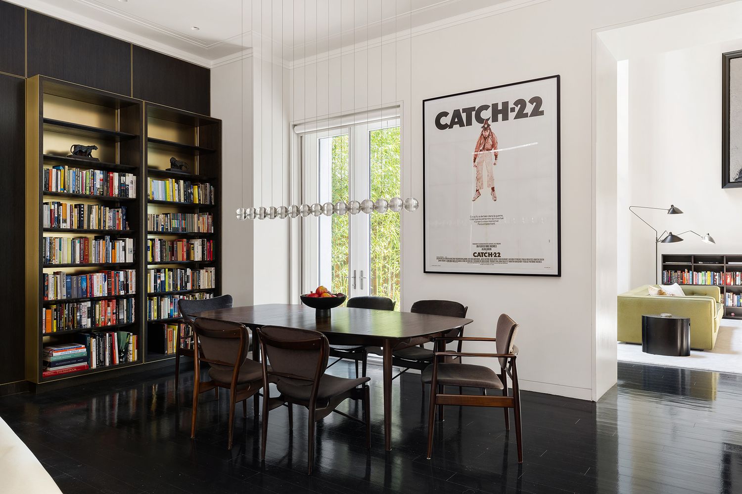 a view of a dining room with furniture and a book shelf
