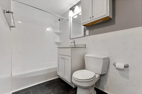 a bathroom with a sink a toilet and bathtub