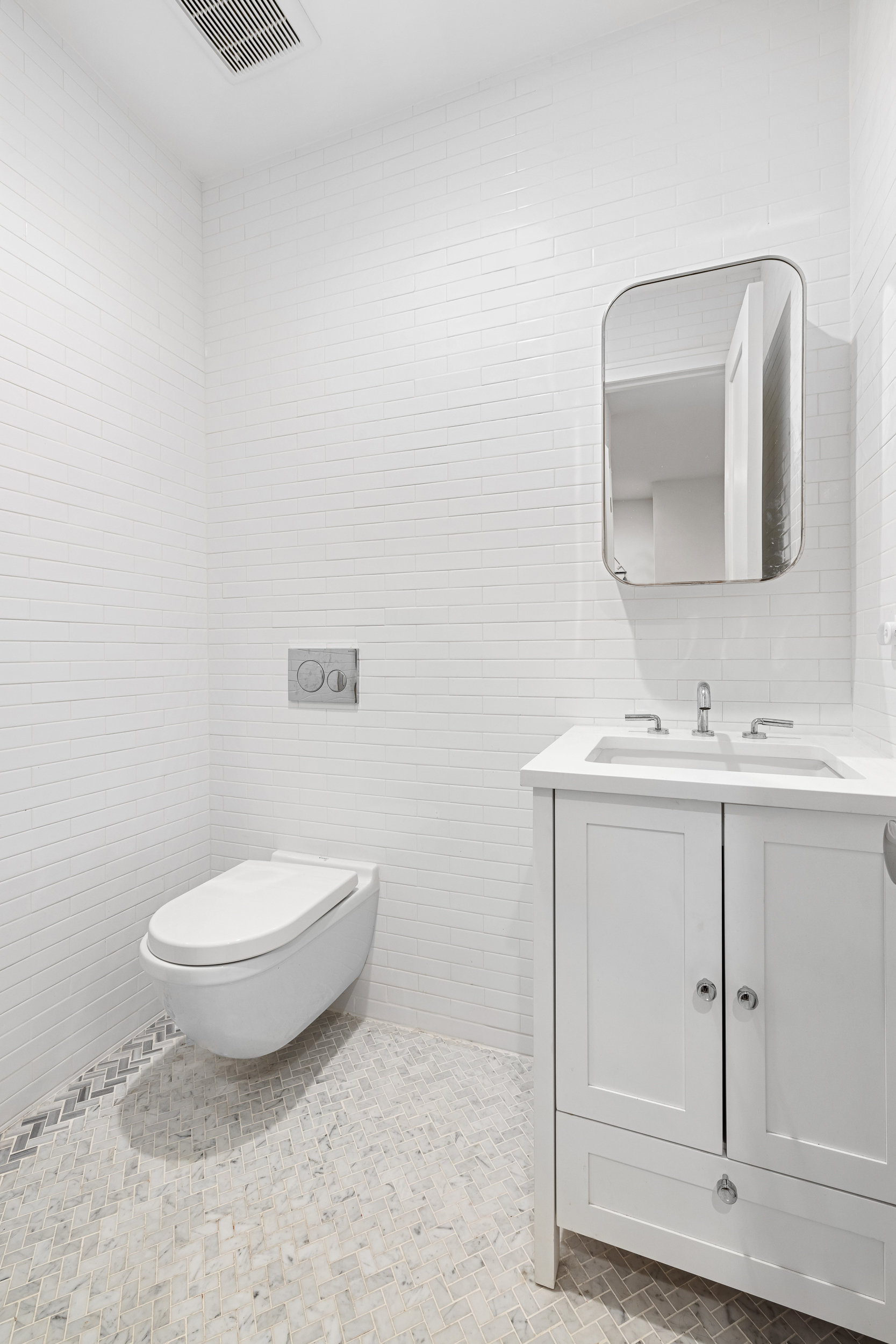 49 East 4th Street Brooklyn, NY 11218 - Photo 14 of 16 a bathroom with a toilet sink and mirror