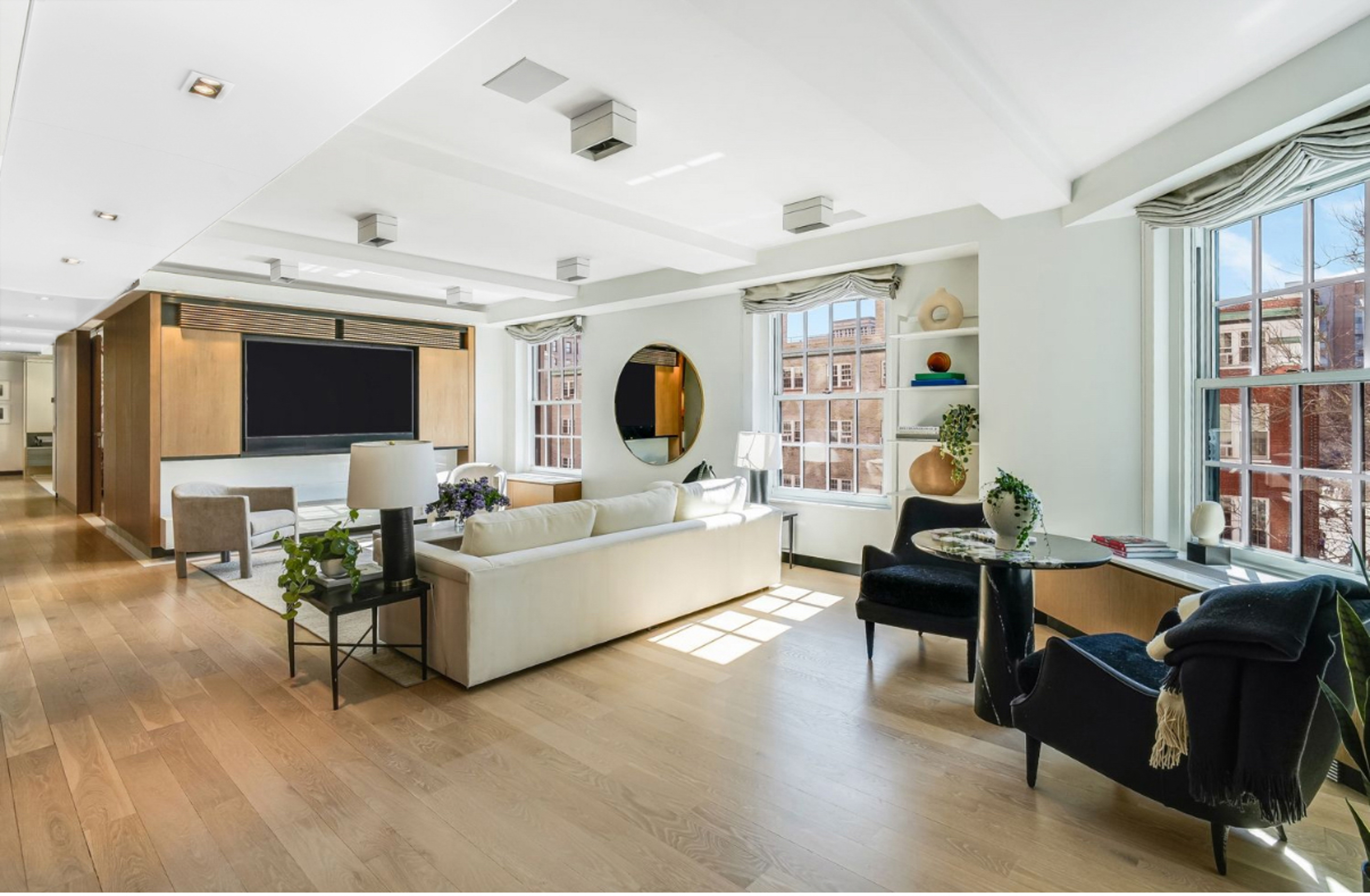 1 5th Avenue, Unit 5GH Manhattan, NY 10003 - Photo 4 of 26 a living room with fireplace furniture and a flat screen tv