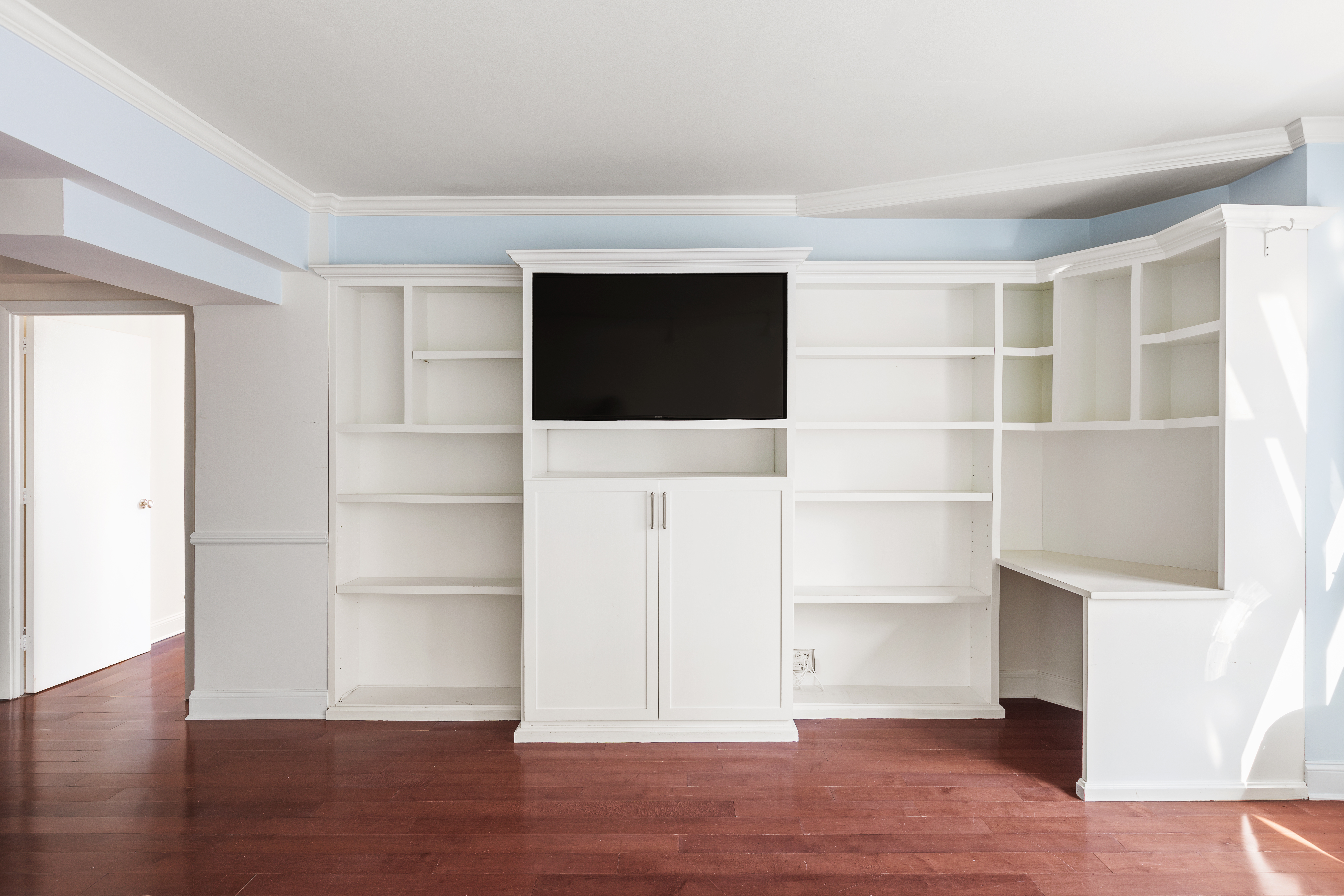 210 East 36th Street, Unit PHC Manhattan, NY 10016 - Photo 3 of 15 a view of a room with wooden floor and flat screen tv