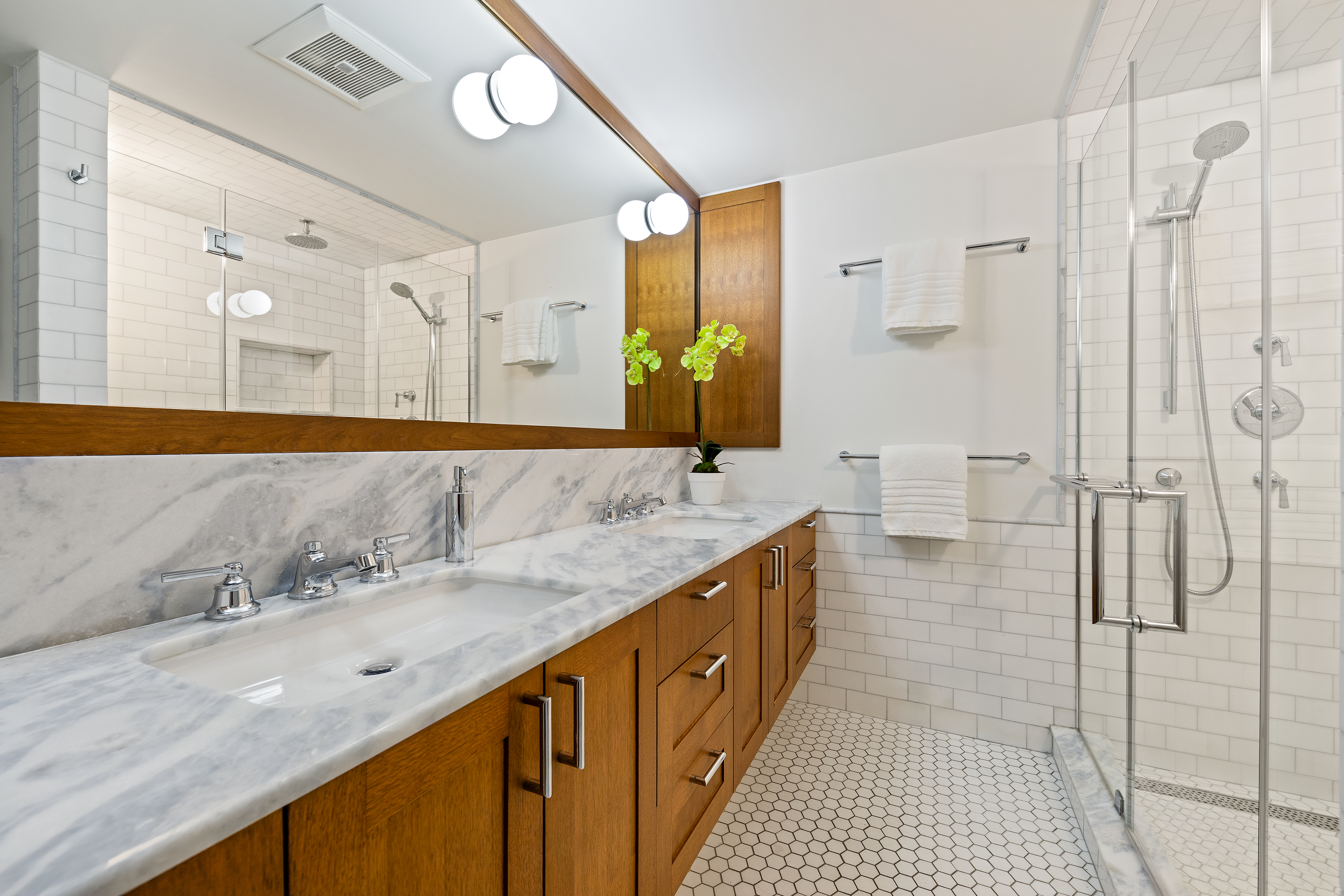 21 Bethune Street, Unit GARDEN Manhattan, NY 10014 - Photo 9 of 12 a bathroom with a double vanity sink and mirror