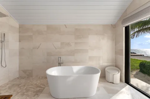 a white bath tub sitting next to a toilet