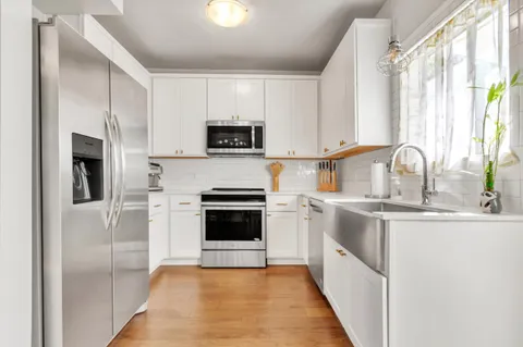 a kitchen with a sink stove and microwave