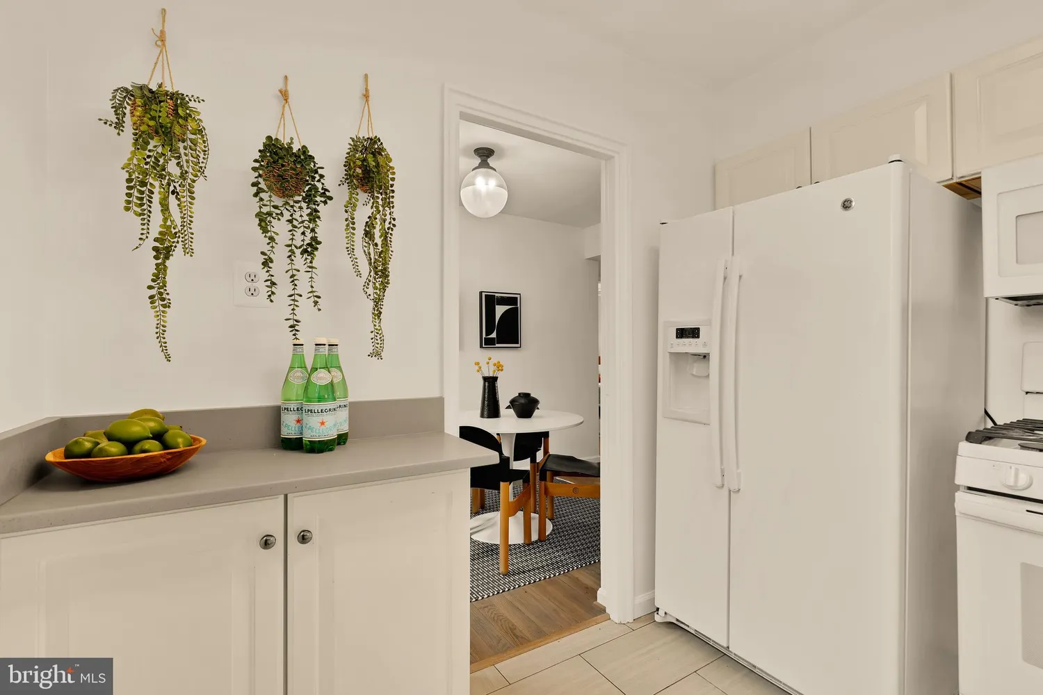 a kitchen with a refrigerator and a table