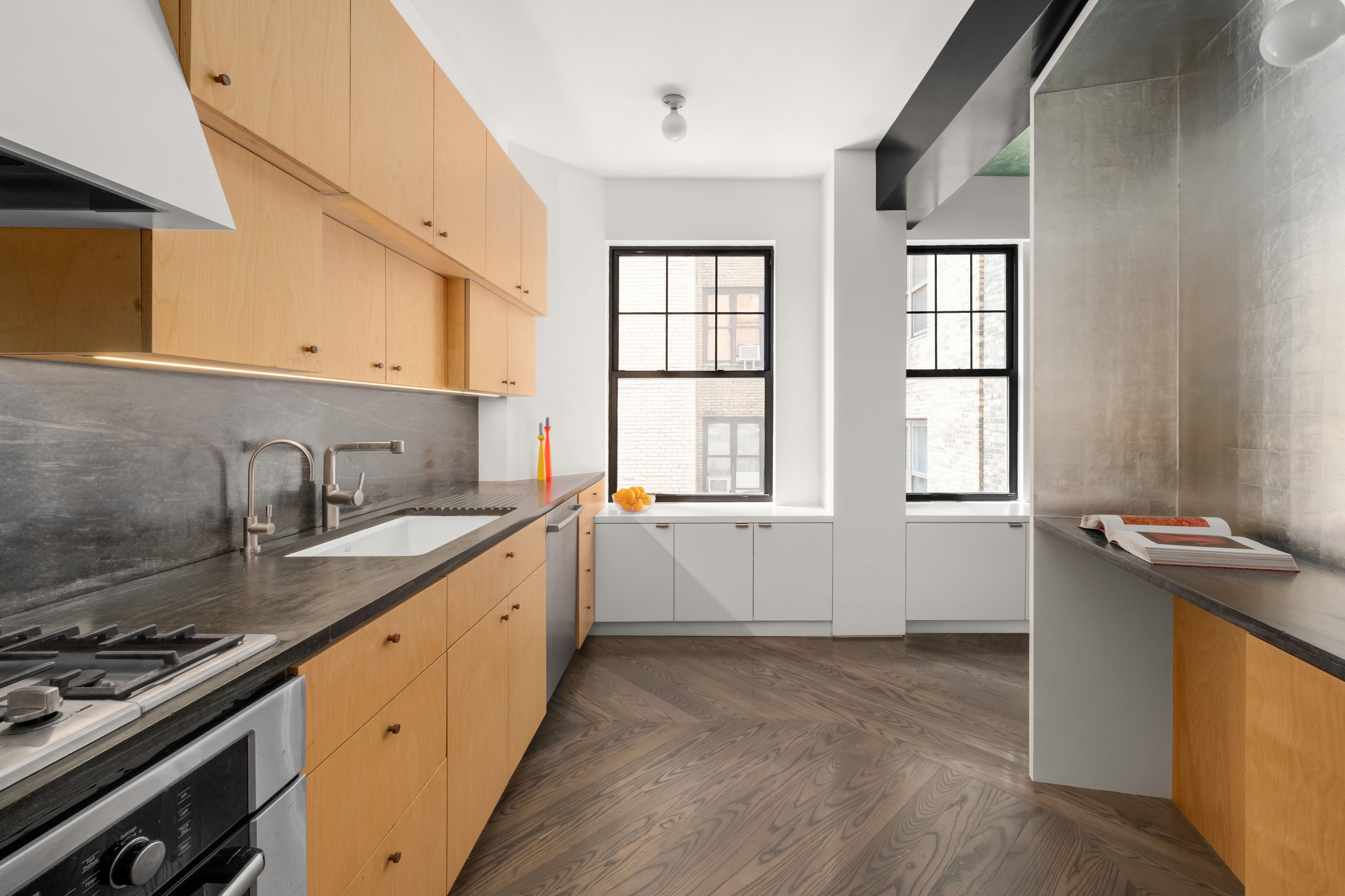 170 2nd Avenue, Unit 5A Manhattan, NY 10003 - Photo 5 of 12 a kitchen with granite countertop a sink stove and cabinets