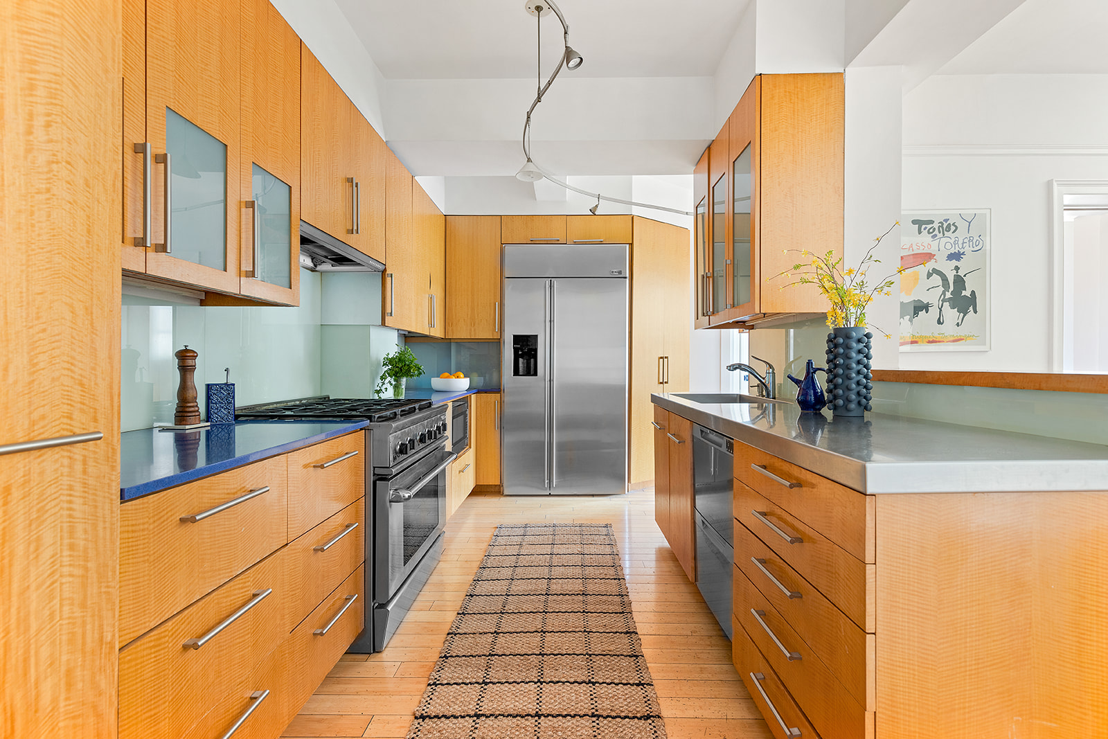 135 Eastern Parkway, Unit 14E Brooklyn, NY 11238 - Photo 4 of 16 a open kitchen with stainless steel appliances granite countertop a sink and cabinets