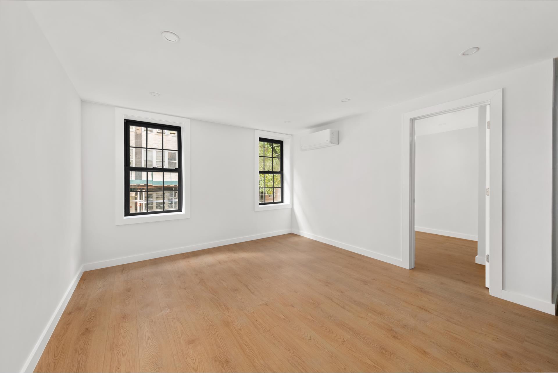 227 East 21st Street, Unit 2F Manhattan, NY 10010 - Photo 3 of 7 an empty room with windows