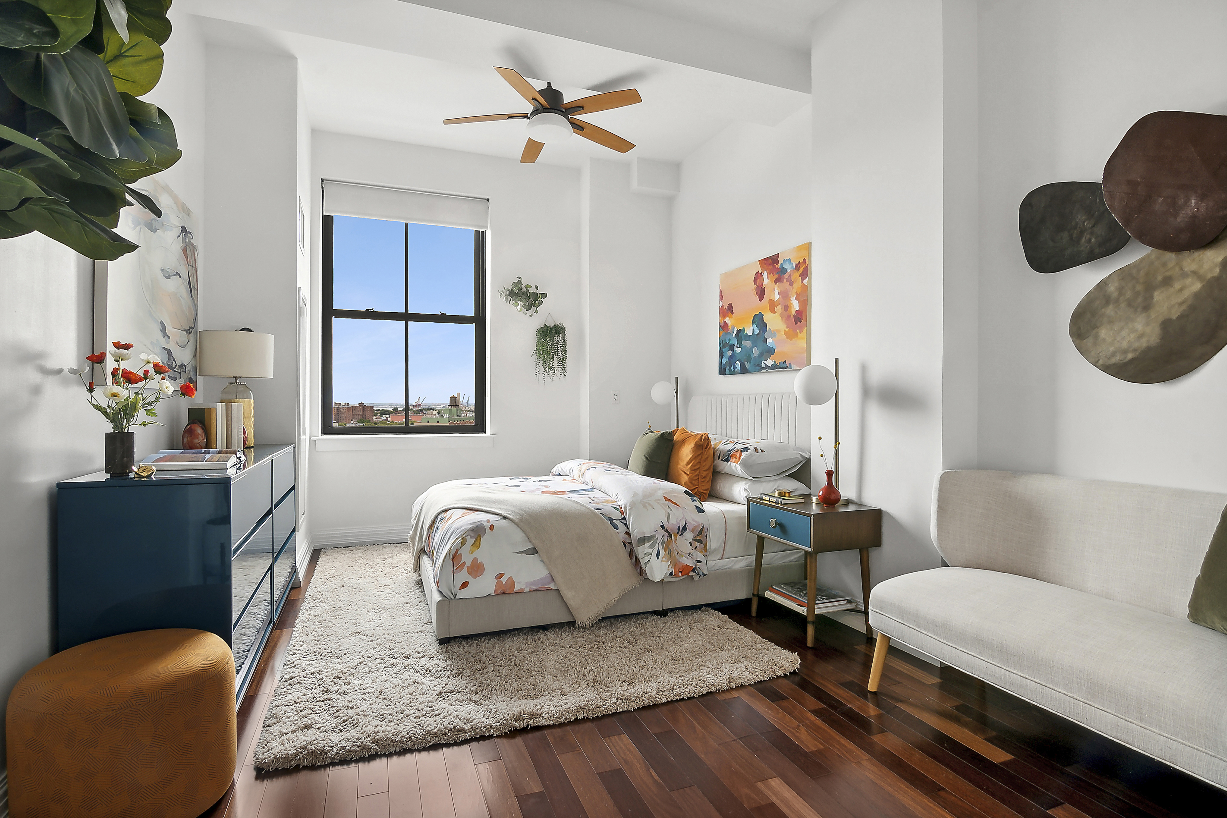 1 Hanson Place, Unit 10H Brooklyn, NY 11243 - Photo 3 of 13 a bedroom with furniture and a potted plant
