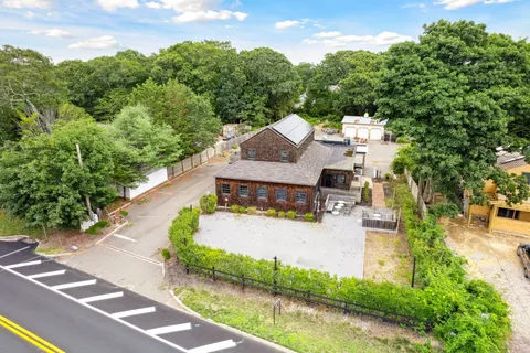 an aerial view of a house with yard and green space