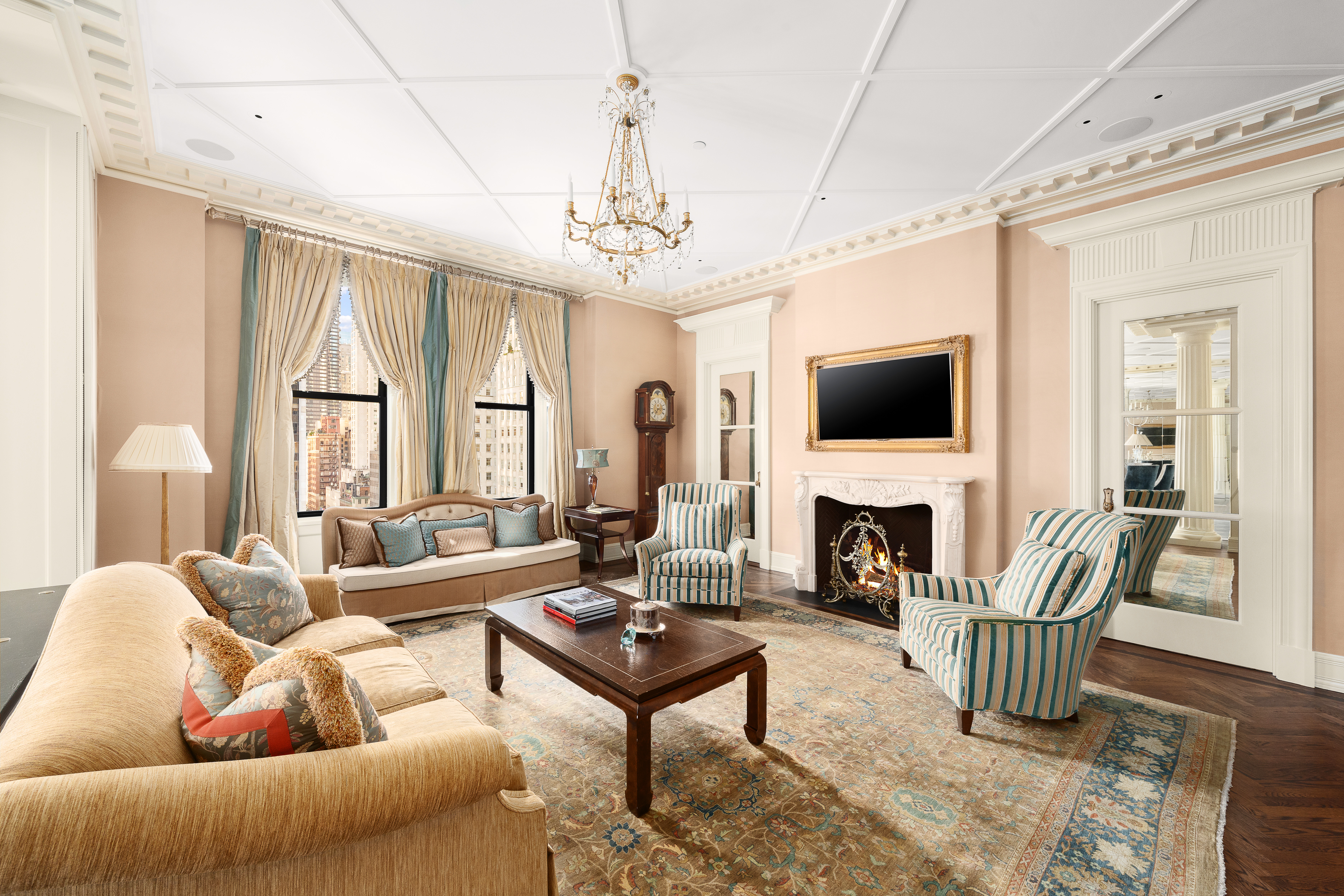 1 Central Park South, Unit 1013 Manhattan, NY 10019 - Photo 6 of 32 a living room with furniture a fireplace and a flat screen tv