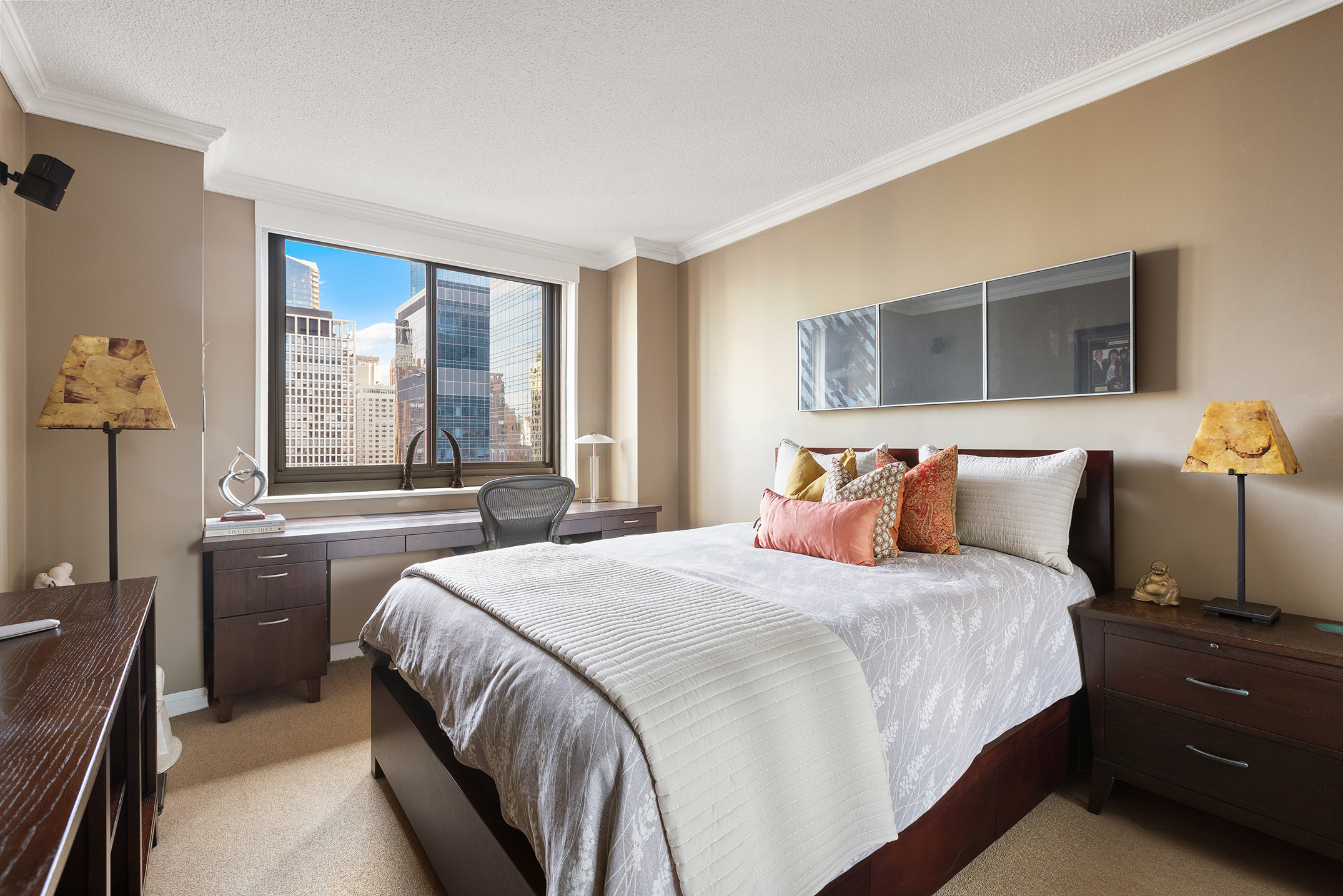 347 West 57th Street, Unit 25AB Manhattan, NY 10019 - Photo 12 of 21 a bedroom with a large bed and a window