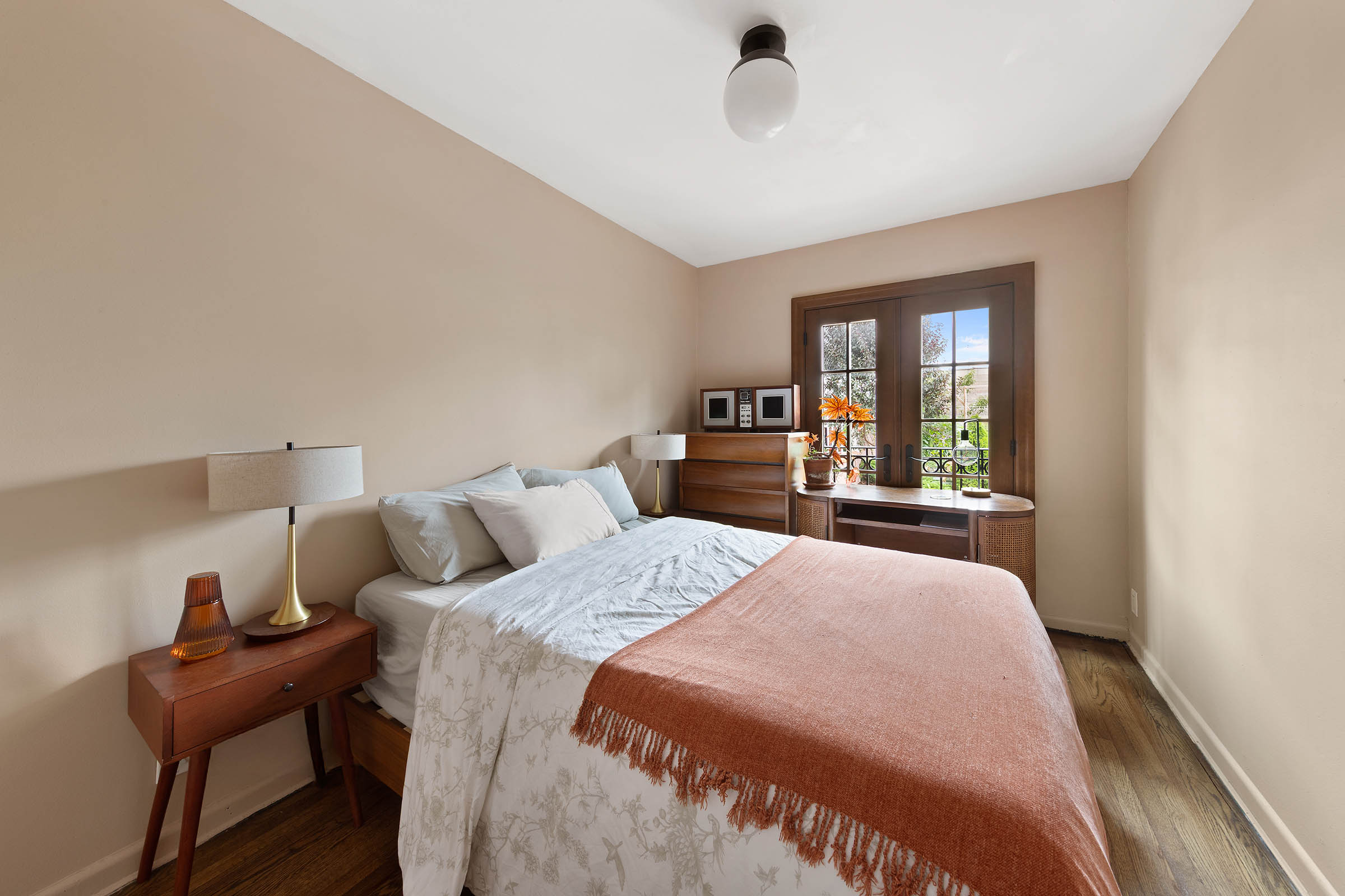 209 Onderdonk Avenue Queens, NY 11385 - Photo 5 of 16 a bedroom with a large bed and a window