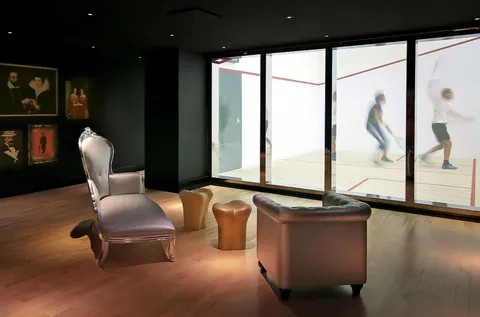 a living room with furniture and floor to ceiling window