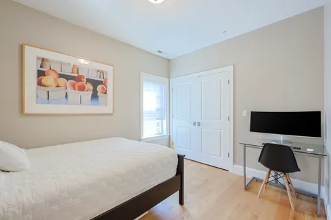 a bedroom with a bed and a workspace