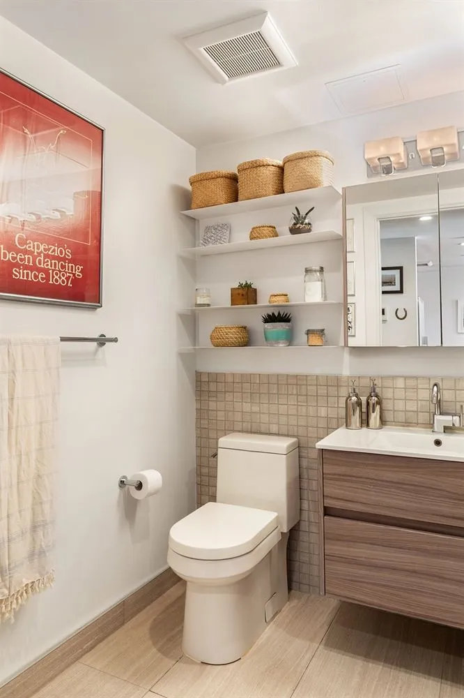 a bathroom with a toilet a sink and mirror