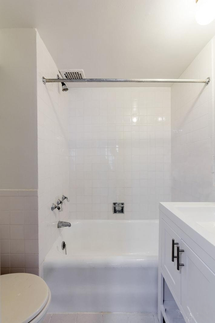 304 East 41st Street, Unit 502A Manhattan, NY 10017 - Photo 3 of 5 a bathroom with a bathtub and a shower