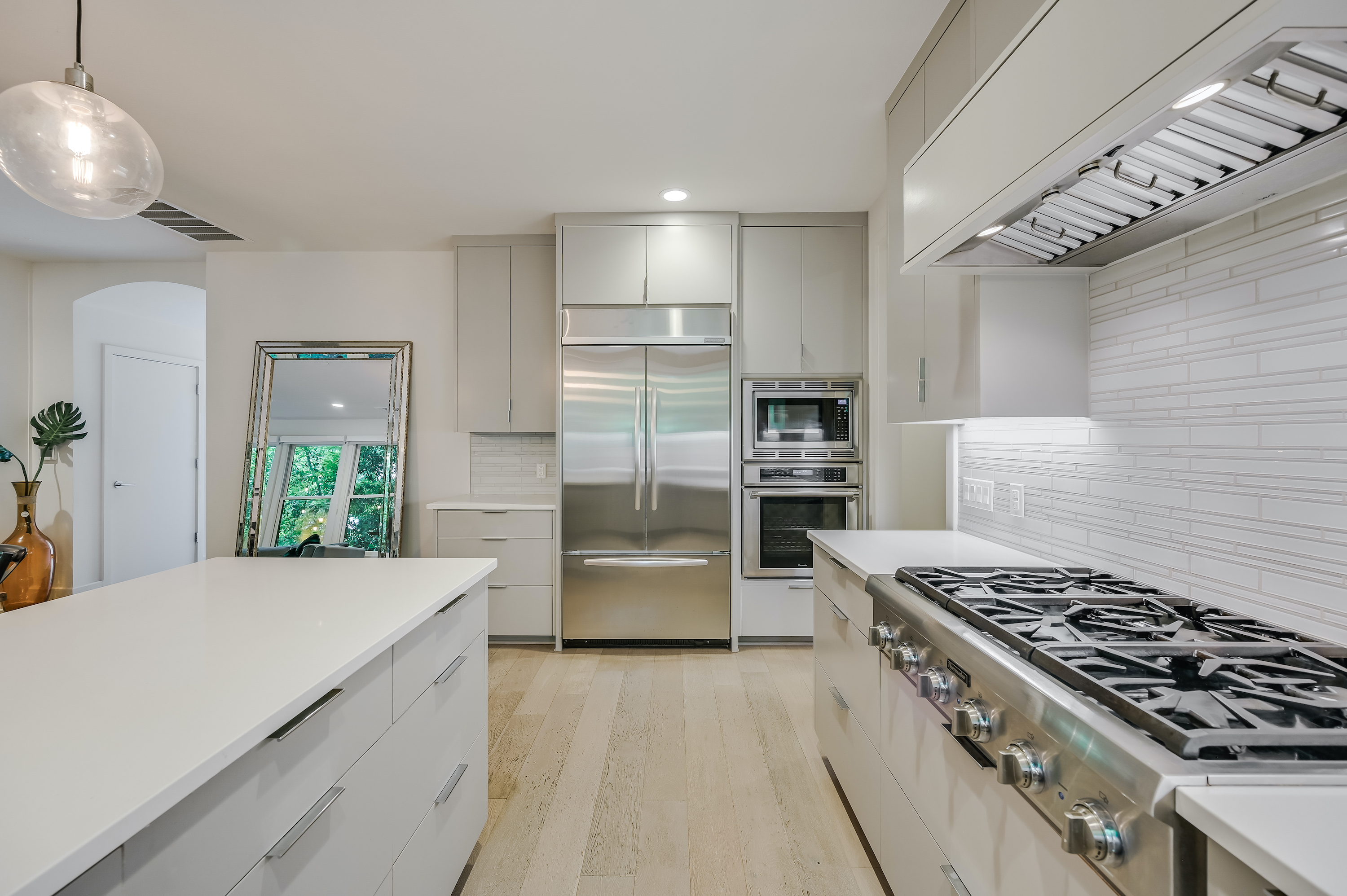 500 South 3rd Street, Unit A Austin, TX 78704 - Photo 11 of 24 a kitchen with stainless steel appliances a sink a stove a refrigerator cabinets and a window