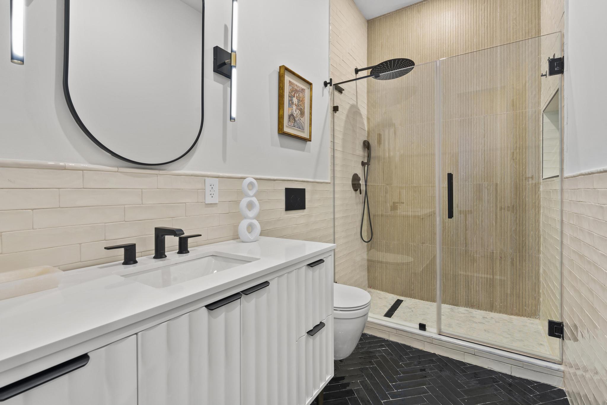 987 Sterling Place Brooklyn, NY 11213 - Photo 9 of 16 a bathroom with a sink a toilet and shower