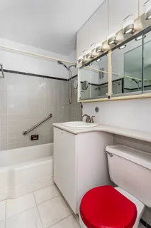 a bathroom with a sink mirror vanity and toilet