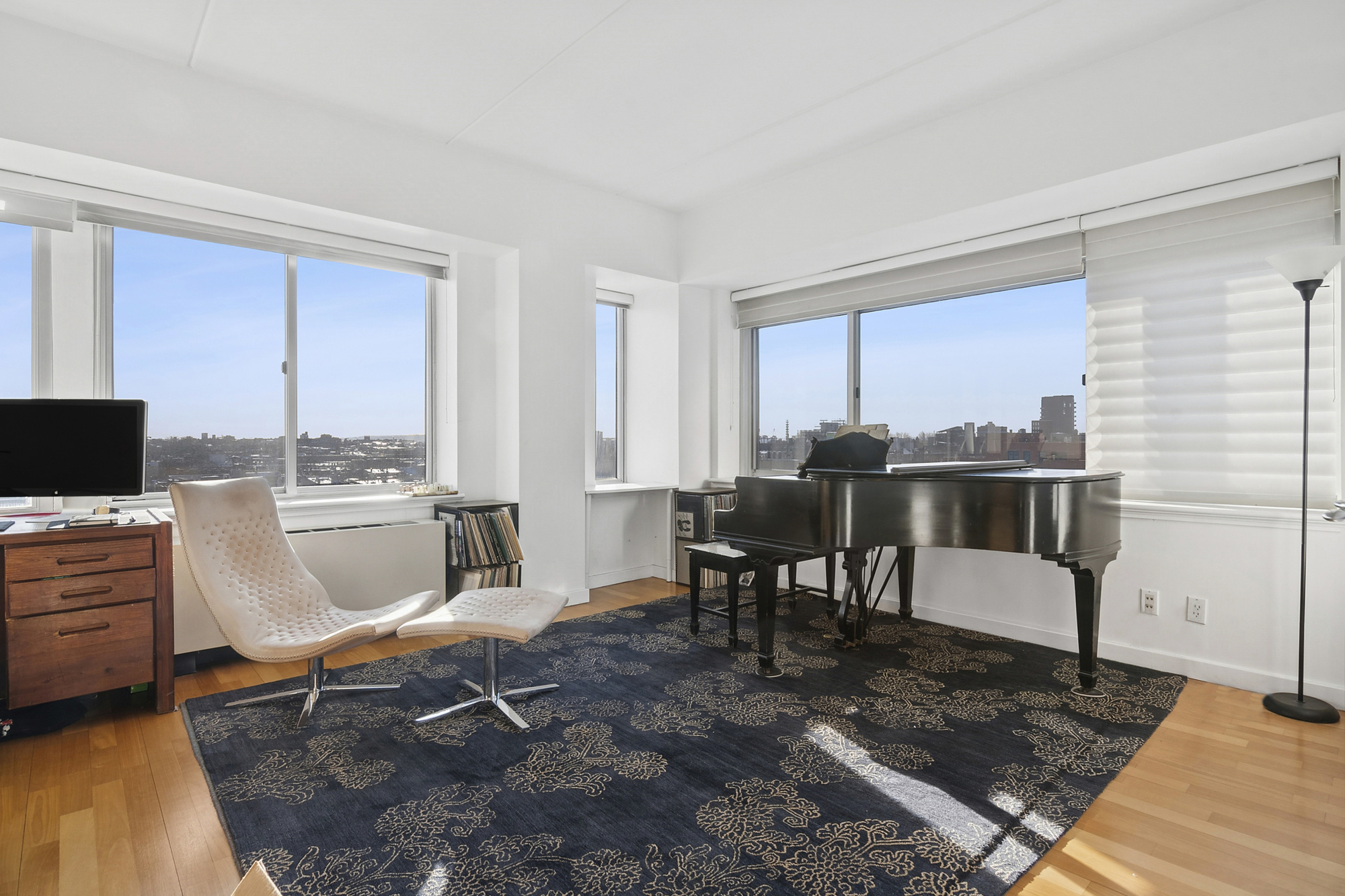 87 Smith Street, Unit 8B Brooklyn, NY 11201 - Photo 3 of 8 a living room with furniture a flat screen tv and kitchen view