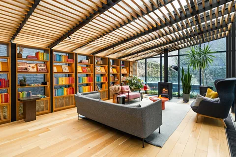 a living room with furniture and large windows