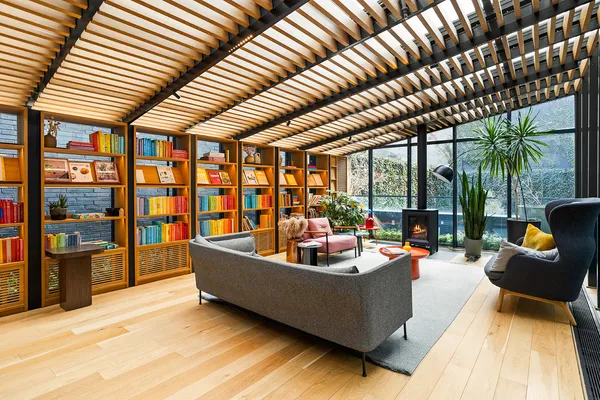 a living room with furniture and large windows