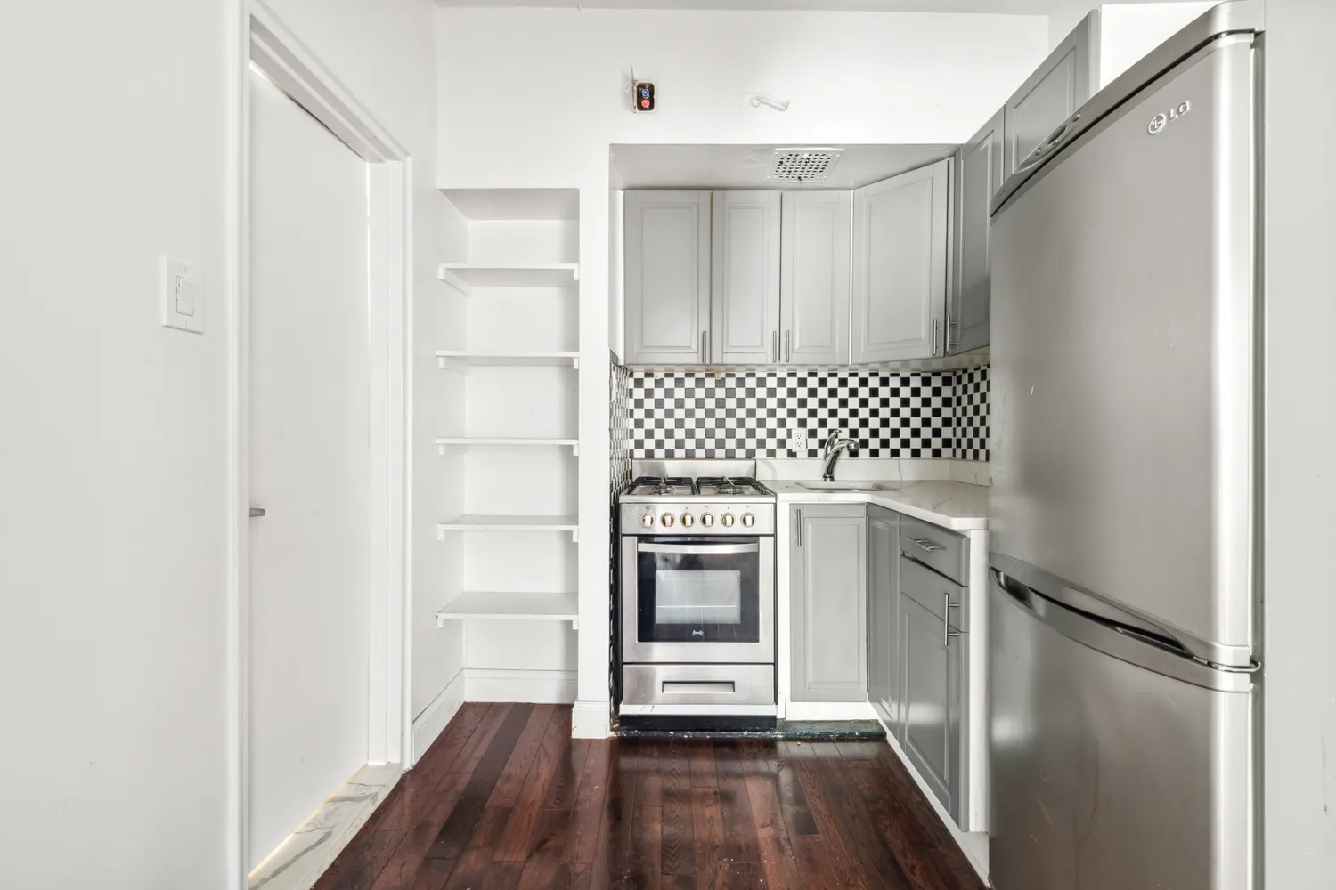 a kitchen with a refrigerator and a stove