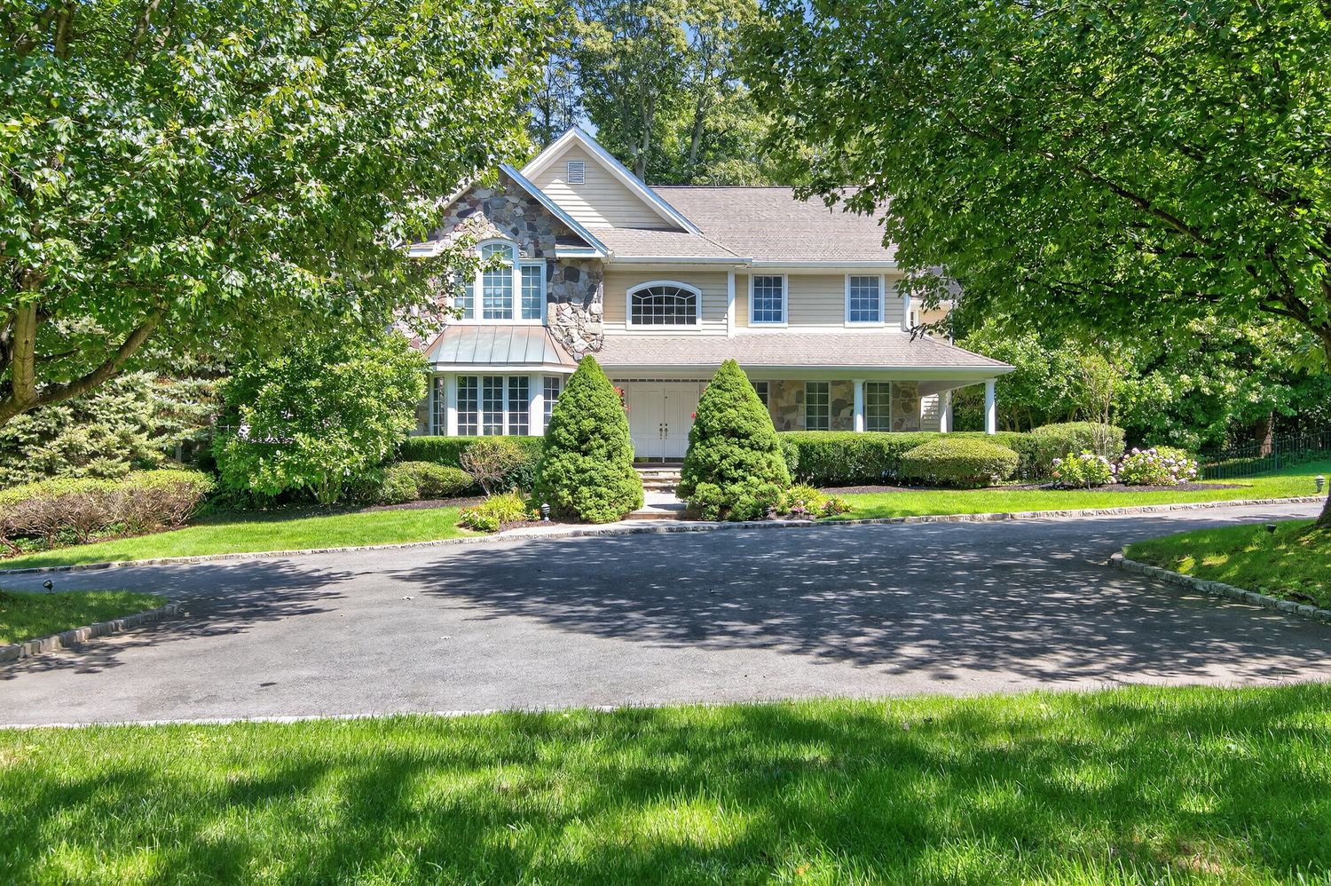 a house with a big yard and large trees
