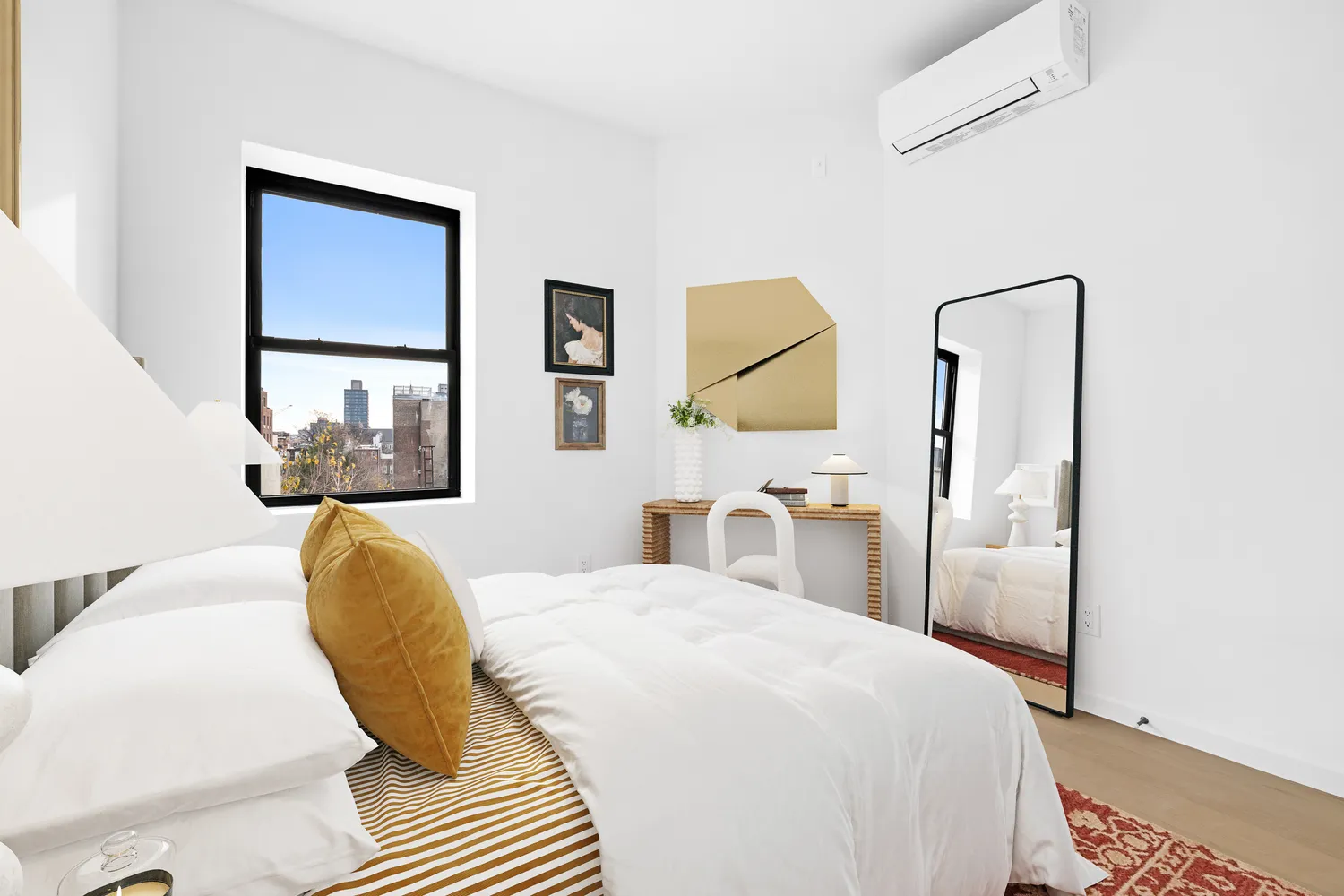 a bedroom with a bed and a painting on the wall