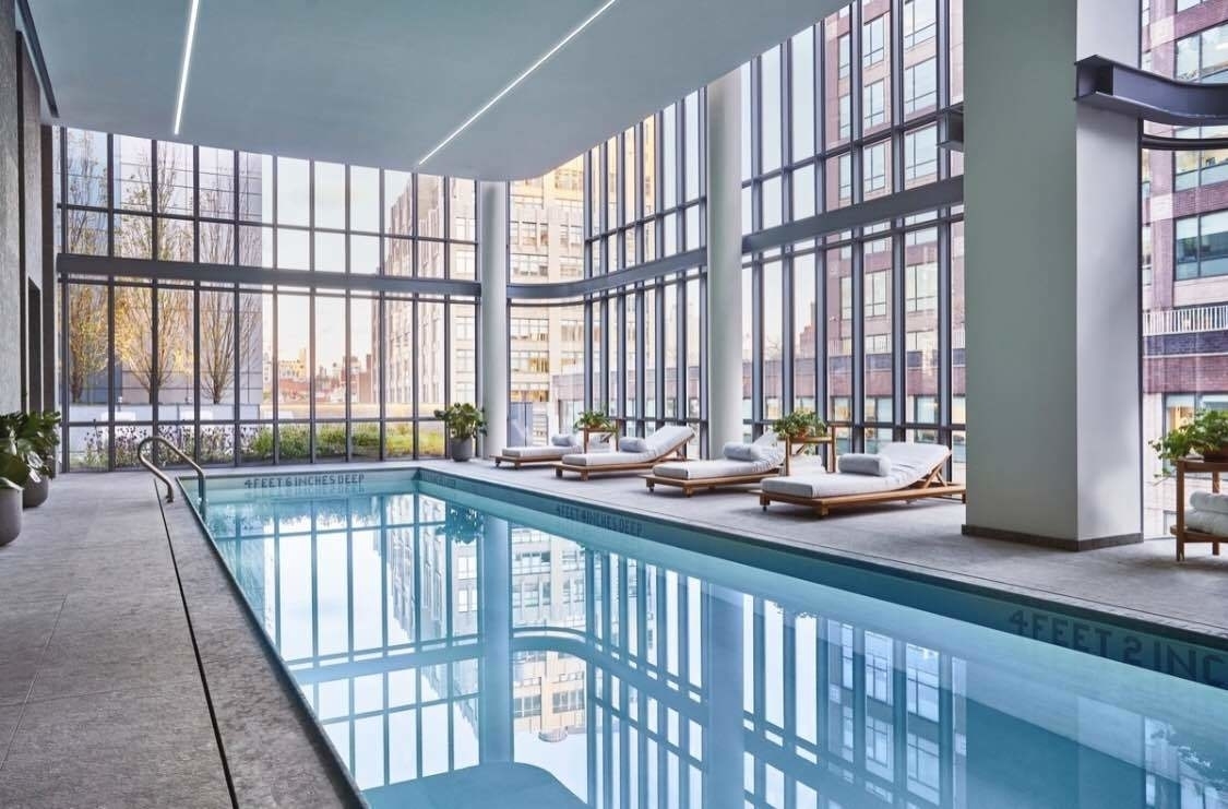 565 Broome Street, Unit S8C Manhattan, NY 10013 - Photo 22 of 24 a view of a large kitchen with furniture and floor to ceiling window