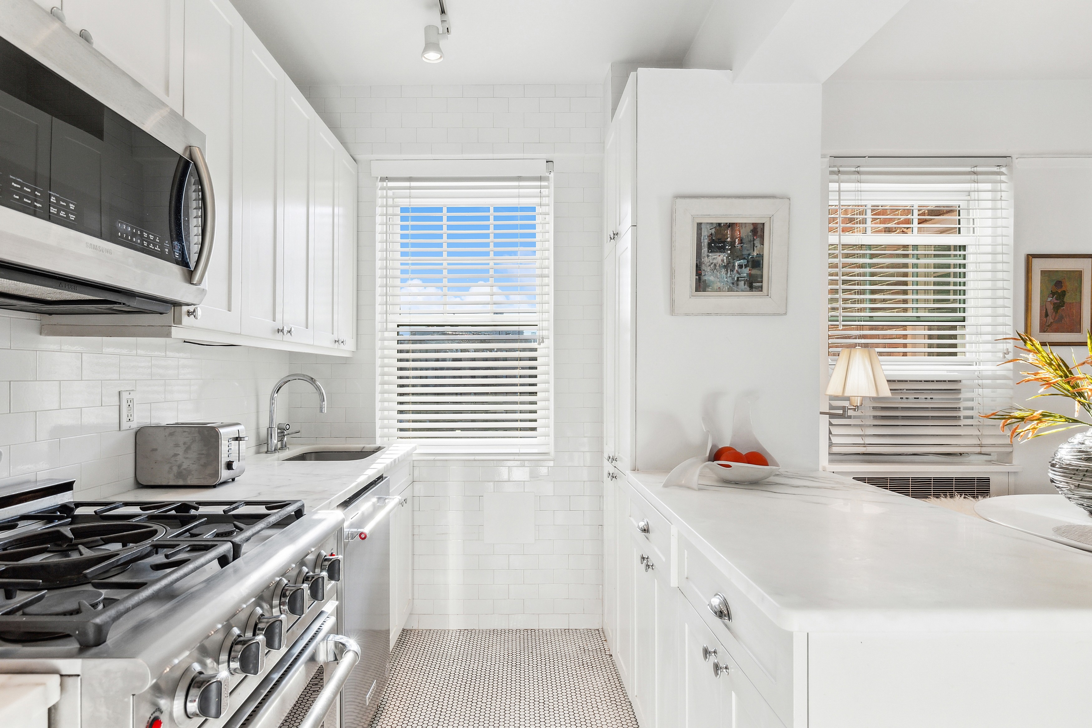 140 Cabrini Boulevard, Unit 92 Manhattan, NY 10033 - Photo 8 of 22 a kitchen with stainless steel appliances a stove a sink a refrigerator and a microwave