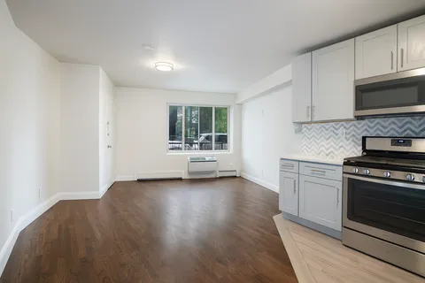 a view of kitchen with wooden floor and electronic appliances