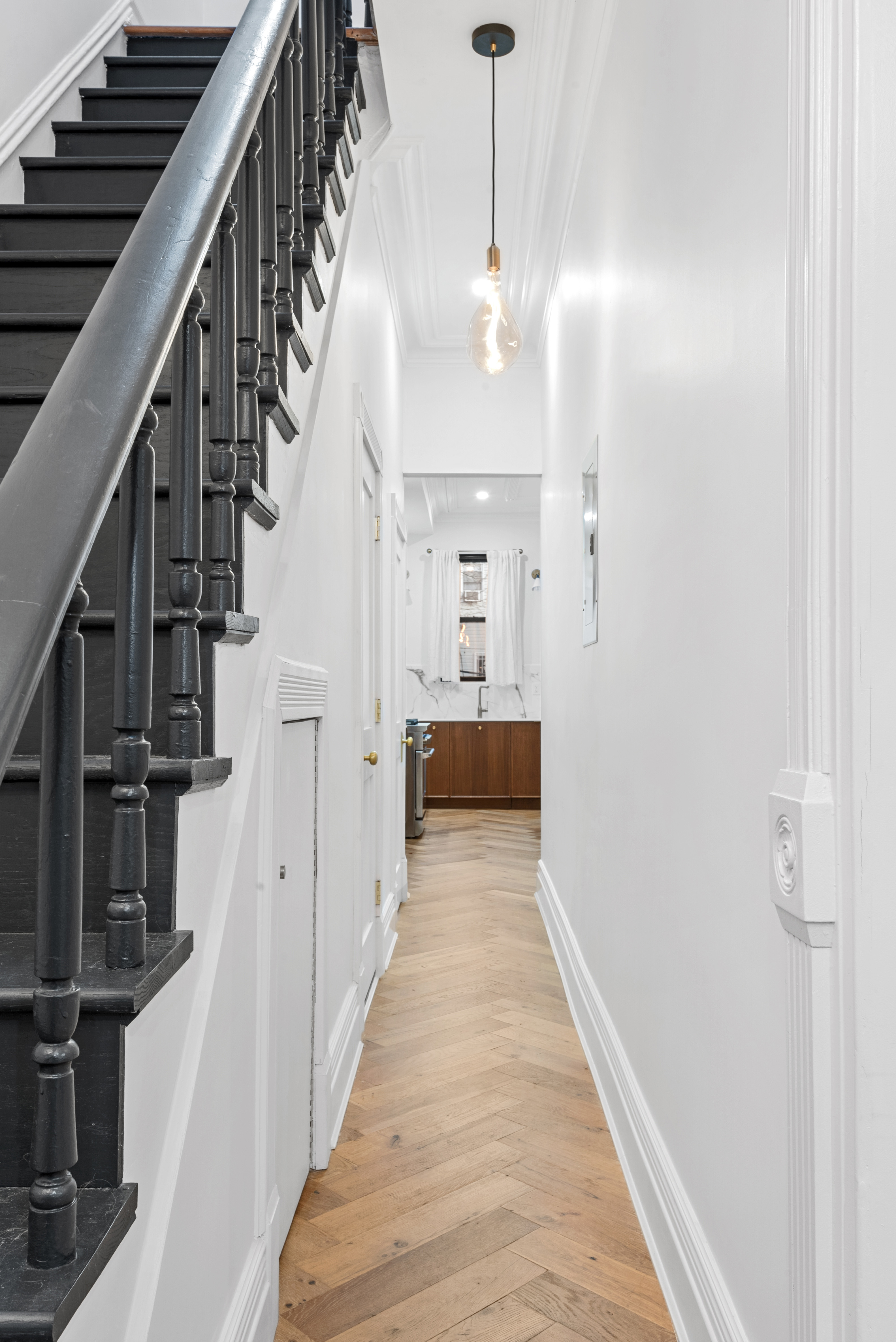30 Weirfield Street Brooklyn, NY 11221 - Photo 18 of 29 a view of a hallway with wooden floor and staircase