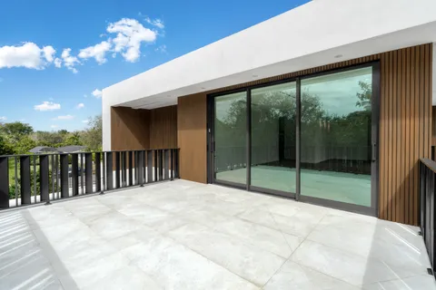 a view of backyard with balcony