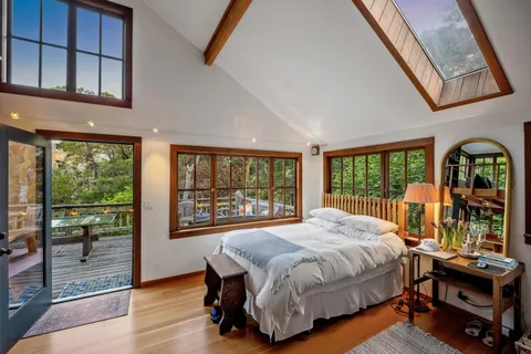 a bed room with a bed and a large window