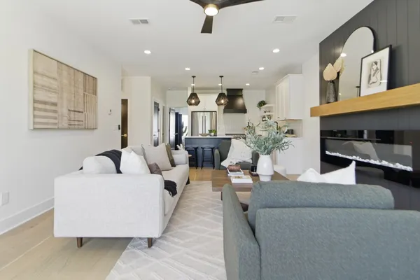 a living room with furniture and a chandelier