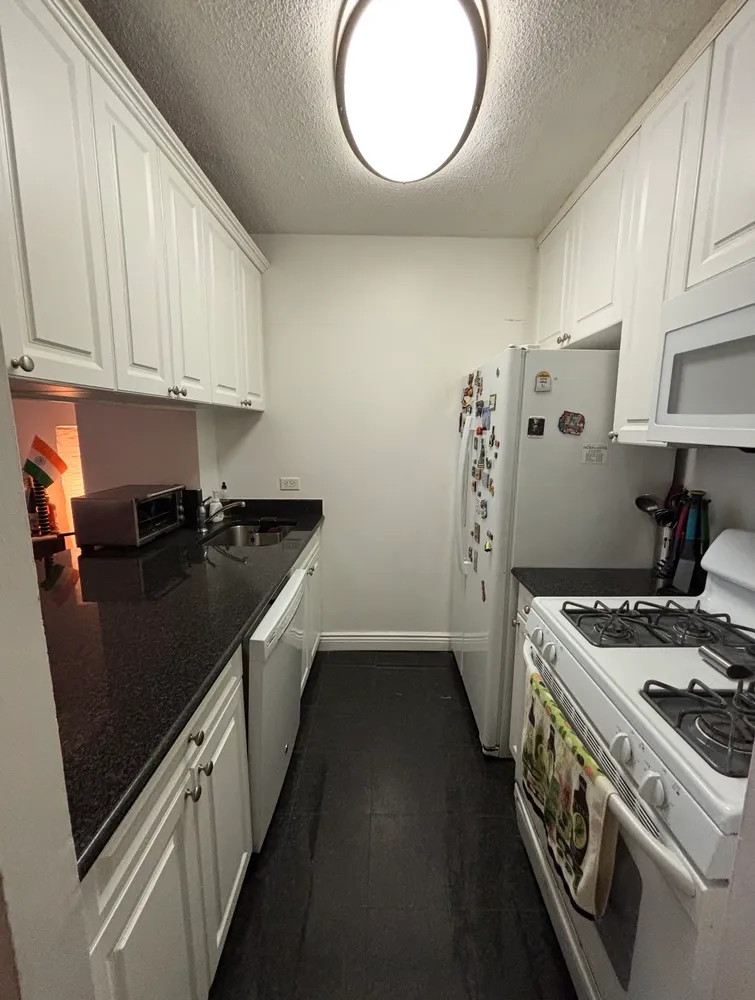 a kitchen with a sink a stove and cabinets